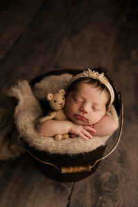 baby in bucket holding a bear in phoenix newborn session