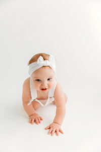 baby girl crawling for milestone pictures in phoenix
