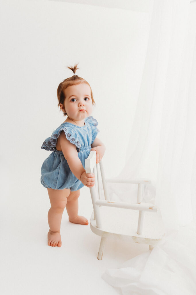 Baby in blue jean romper for portraits in Phoenix