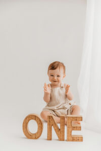 Baby playing during phoenix cake smash portrait session