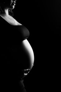 black and white maternity silhouette portrait at luxury maternity photographer studio