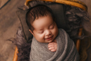 Baby smiling in  newborn session in Phoenix newborn photography studio newborn portraits in phoenix 