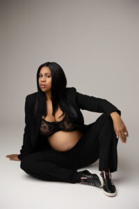 Mother posing in suit with louboutin shoes for maternity photography session in phoenix