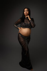 black mother in jeweled two piece outfit for maternity portrait session in phoenix maternity studio