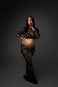 black mother in jeweled two piece outfit for maternity portrait session in phoenix maternity studio