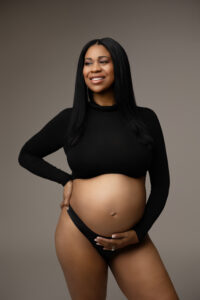 black mom posing in crop top for phoenix maternity session 