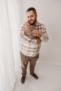 Dad with baby in newborn session in phoenix