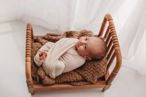 Baby boy posing in newborn session at phoenix portrait studio