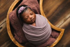 African American baby posing for baby portraits in Phoenix newborn studio creative newborn session ideas