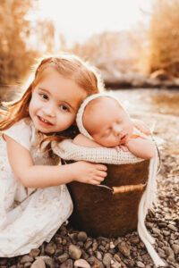 little girl cuddling with baby for a photography session