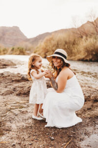 mom and daughter smiling during photography session at the salt river