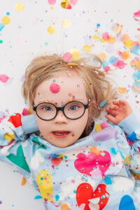 child with Down syndrome playing during mini session in Phoenix studio 