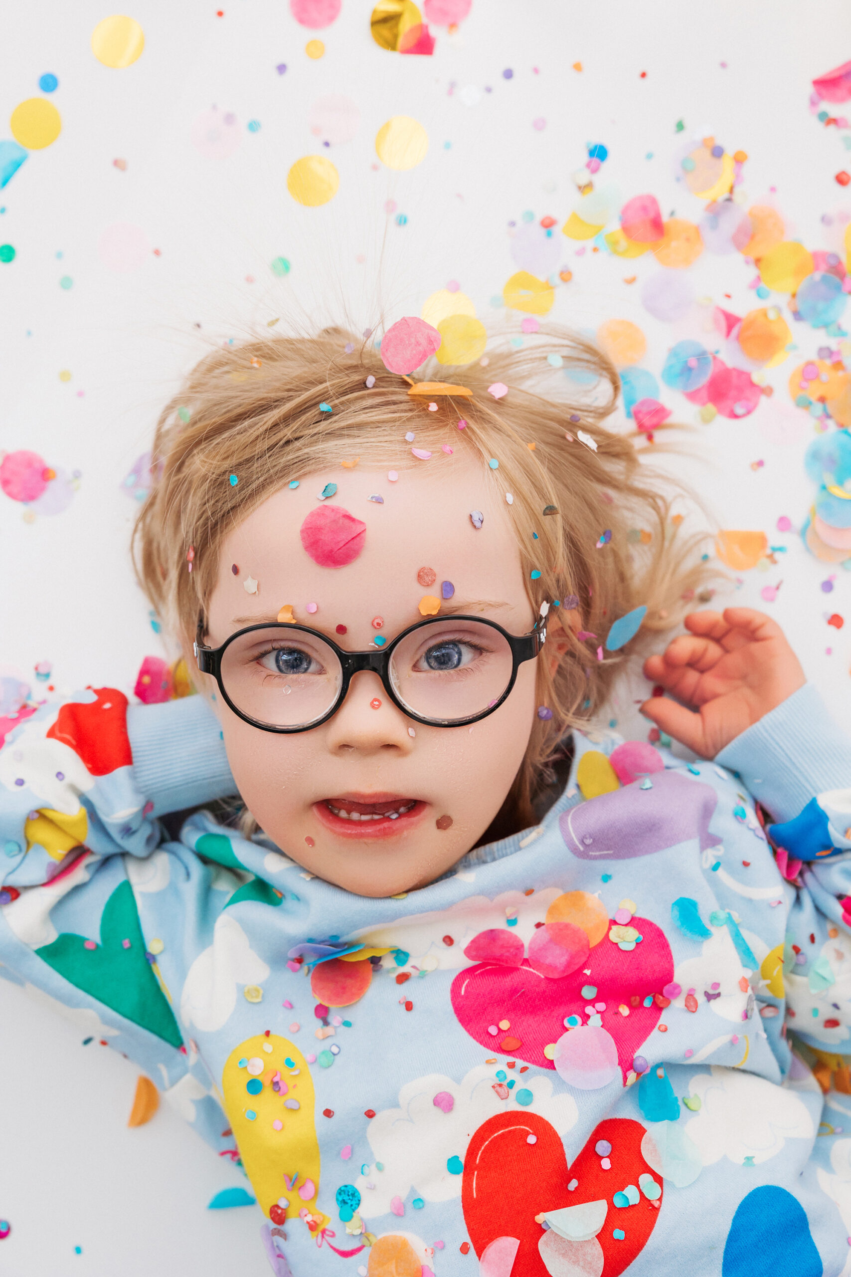 child with Down syndrome playing during mini session in Phoenix studio