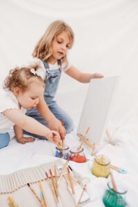 Sisters painting during photography session in Phoenix mini session