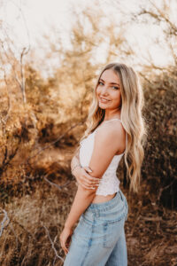 Girl with blonde hair in senior session at lost dutchman state park