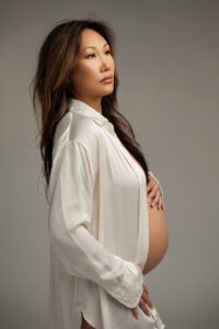 Pregnant woman in silk shirt for studio maternity portraits in Phoenix