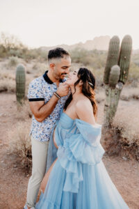 Phoenix sunset maternity session at the salt river with mom in blue dress posing with husband