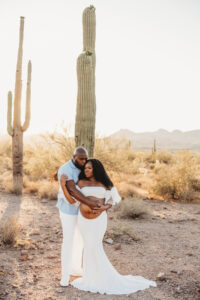 Black pregnant mom in white dress at lost dutchman state park maternity session with black husband