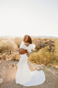 Black pregnant mom in white dress at lost dutchman state park maternity session 