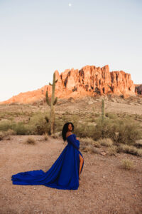 Sunset maternity session at lost dutchman state park with black mom  in blue dress and husband for destination maternity session