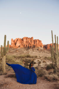 Sunset maternity session at lost dutchman state park with black mom  in blue dress and husband 