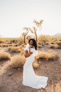 Black pregnant mom in white dress at lost dutchman state park maternity session 