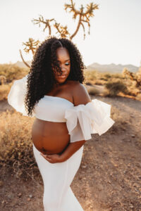 Black pregnant mom in white dress at lost dutchman state park maternity session 