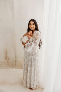 Mom holding newborn baby during lifestyle newborn session in phoenix