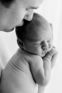 Father holding son during Phoenix Lifestyle newborn picture session