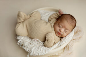 Baby boy in tan during newborn session in Phoenix