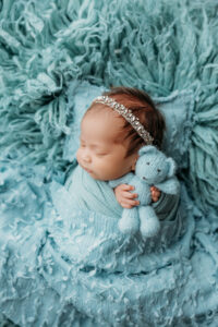 baby girl holding bear for phoenix newborn session
