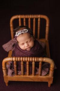 baby girl in purple set up for baby pictures in phoenix