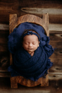 Baby girl in navy blue set up for phoenix newborn session