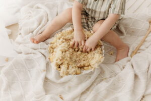 baby smashing cake at 2nd birthday session