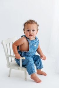 baby boy in overalls for phoenix cake smash session 