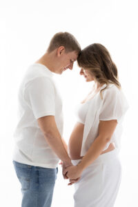 Couples posing during maternity session in phoenix
