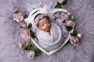 Black baby girl in purple newborn props at phoenix photography newborn studio
