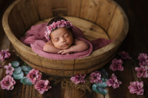 Black baby girl in bowl with pink flowers