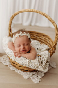 baby girl in basket during newborn photography session in gilbert AZ 