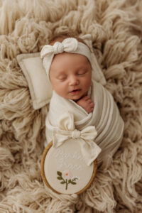 baby on brown rug during newborn pictures
