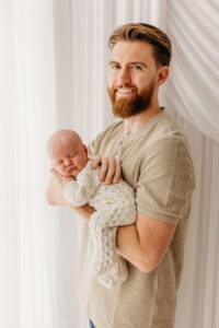 dad holding baby during photoshoot