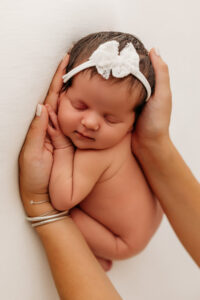 baby in hands arizona newborn photoshoot