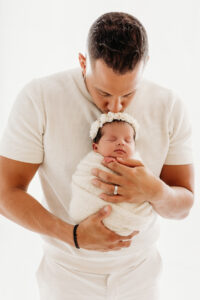 dad kissing baby arizona newborn photoshoot