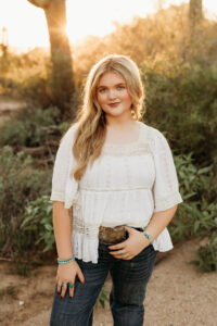 high school senior girl wearing jeans in phoenix desert for senior pictures